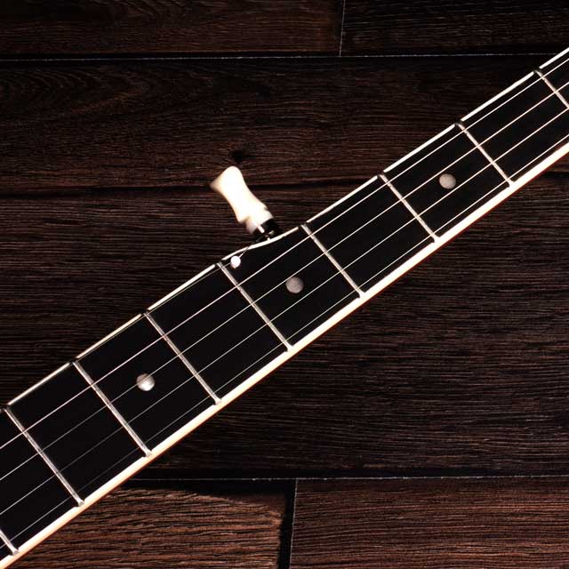How high should the strings be above the frets? 